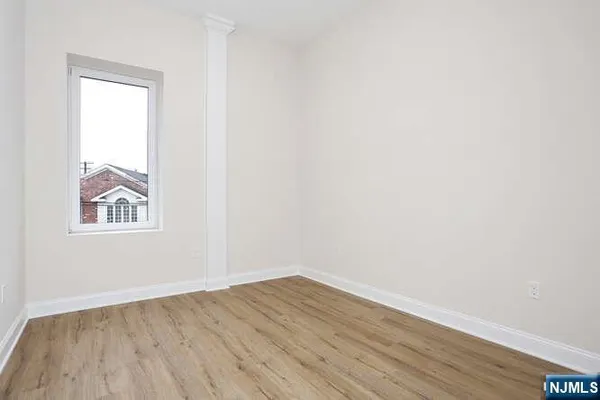 an empty room with wooden floor