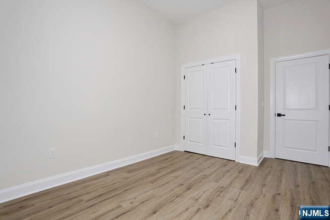385 Passaic Avenue, Unit 6 Lodi, NJ 07644 - Photo 17 of 23 an empty room with wooden floor