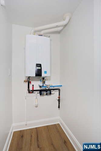 385 Passaic Avenue, Unit 6 Lodi, NJ 07644 - Photo 20 of 23 a view of a storage & utility room with wooden floor