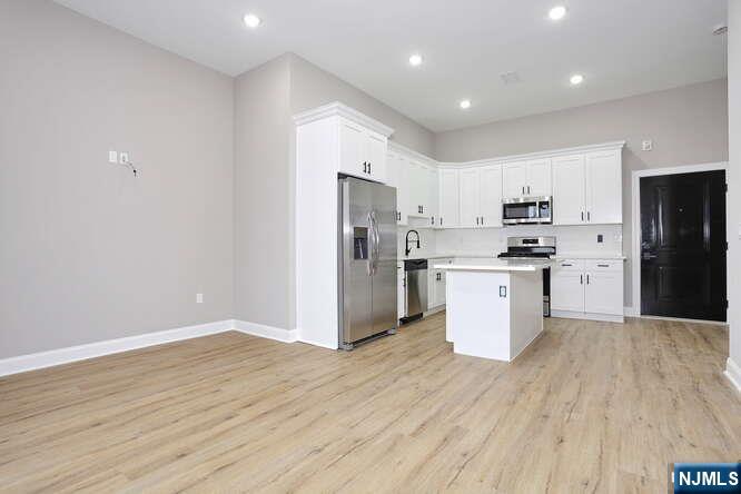 385 Passaic Avenue, Unit 6 Lodi, NJ 07644 - Photo 7 of 23 a kitchen with a refrigerator and a sink