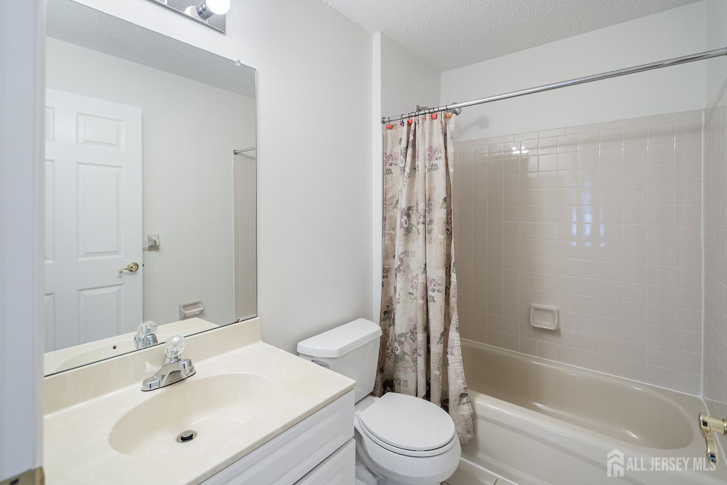 116 Prestwick Way Edison, NJ 08820 - Photo 21 of 27 a bathroom with a bathtub shower sink vanity and toilet