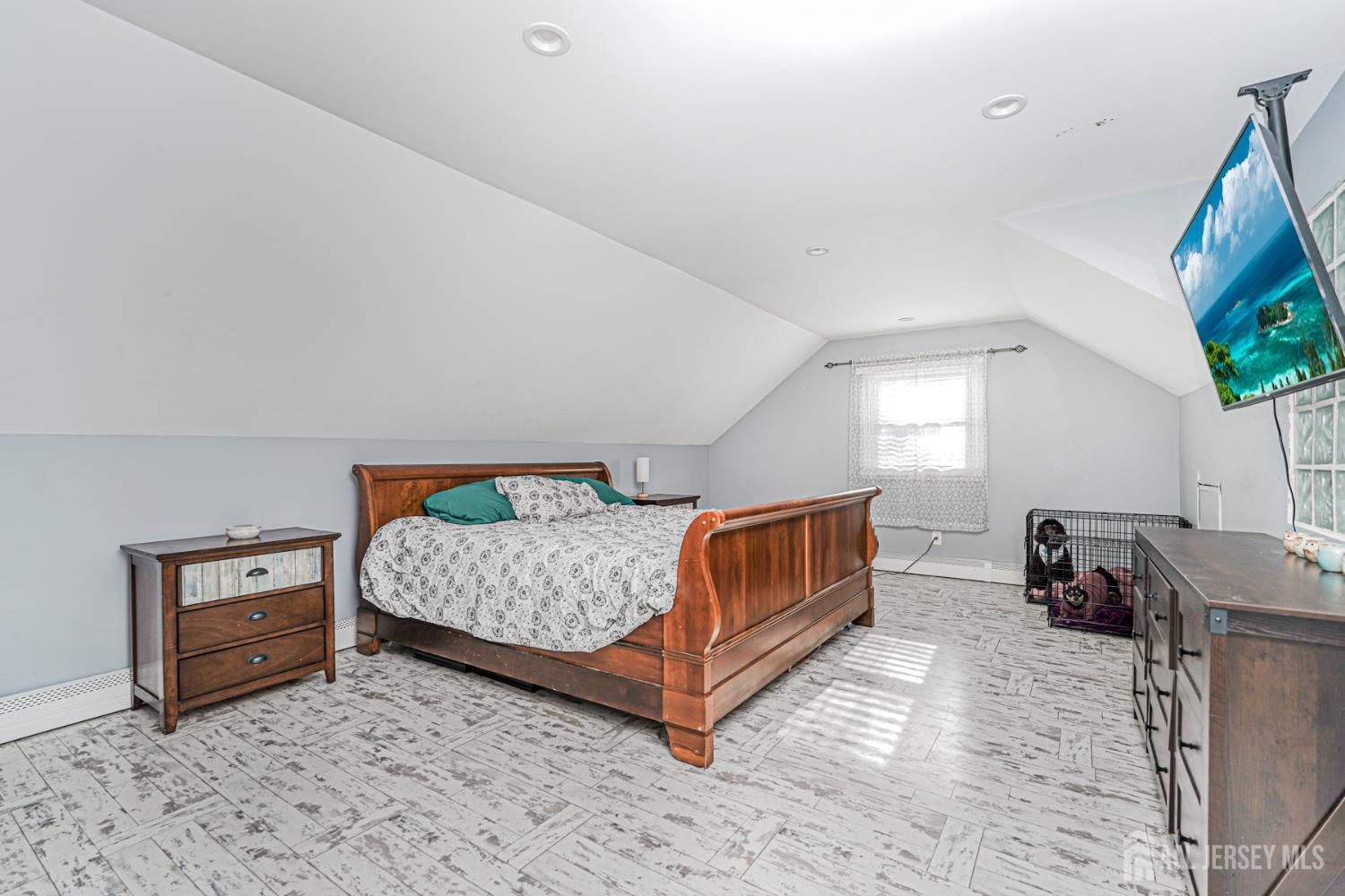 7 Walnut Lane Parlin, NJ 08859 - Photo 14 of 22 a view of a bedroom with furniture and a flat screen tv