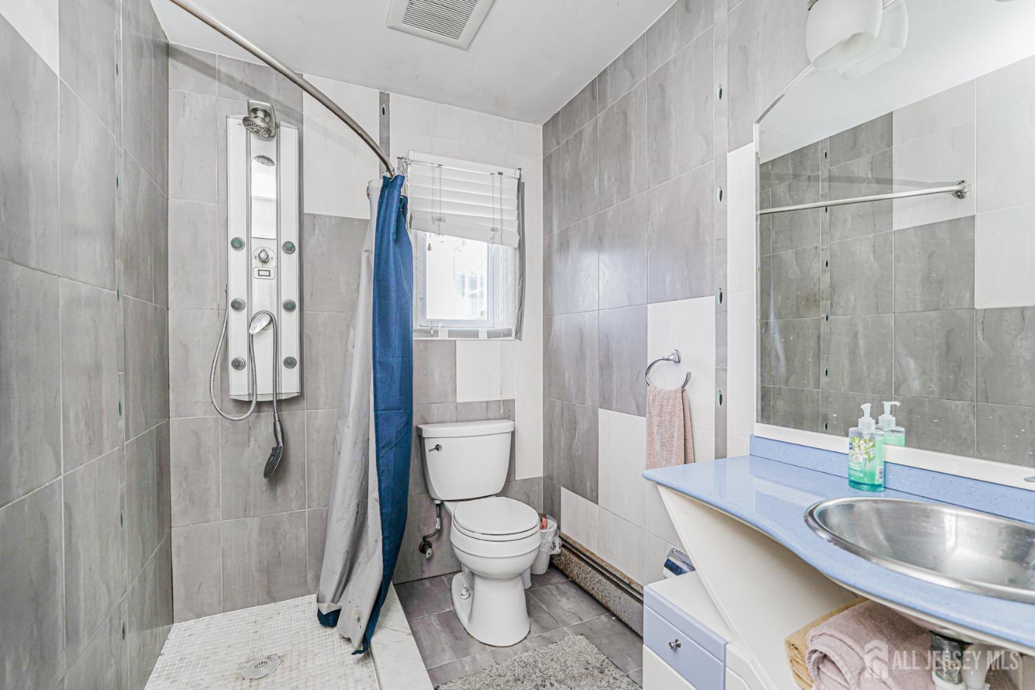 7 Walnut Lane Parlin, NJ 08859 - Photo 17 of 22 a bathroom with a granite countertop sink toilet and shower