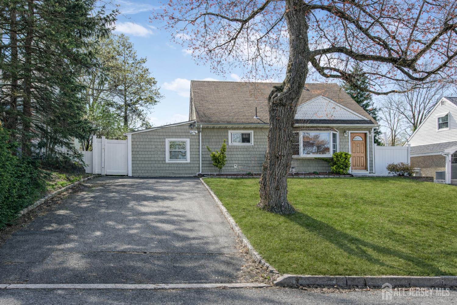 7 Walnut Lane Parlin, NJ 08859 - Photo 2 of 22 a front view of a house with a yard and trees