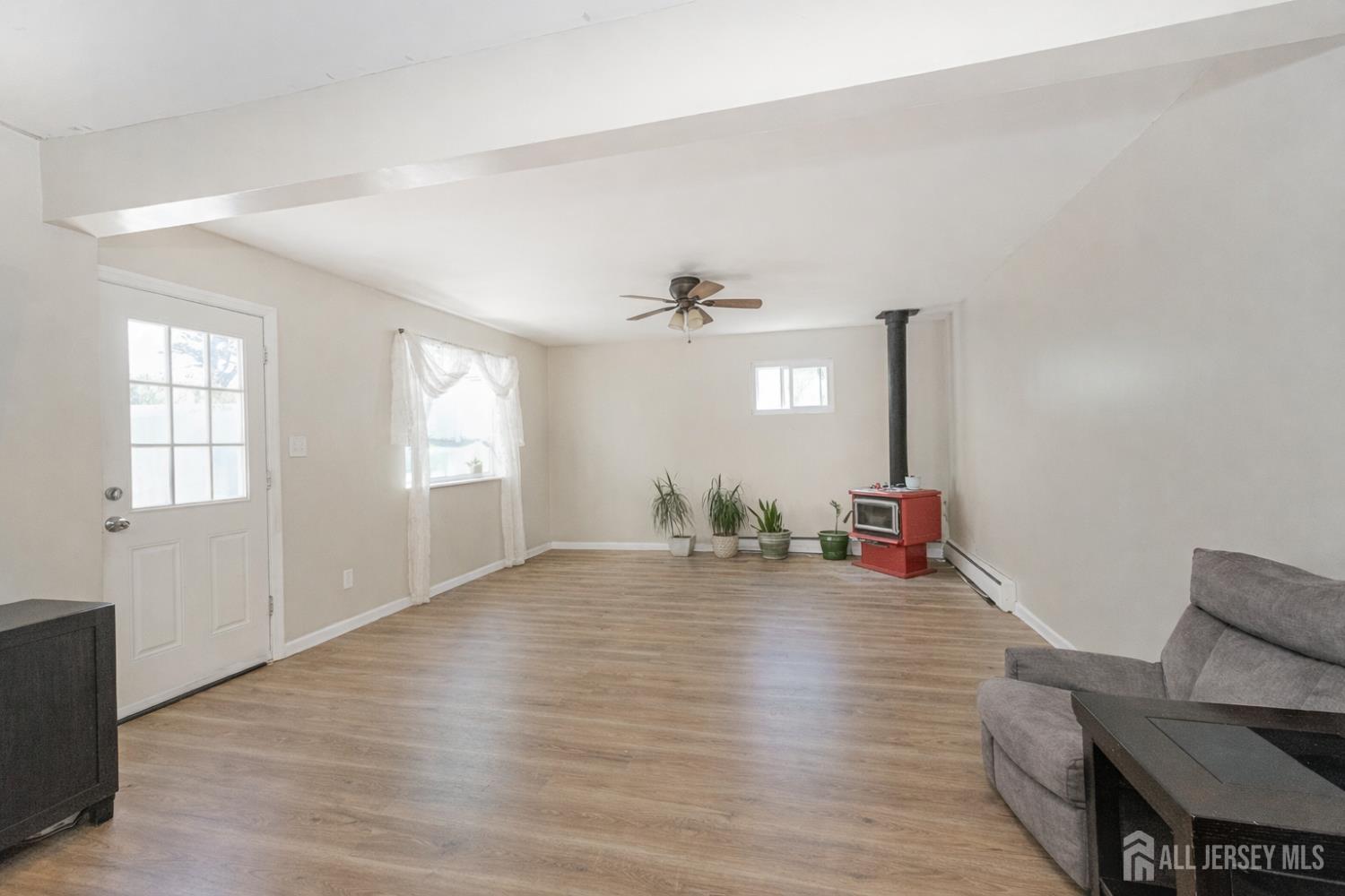 7 Walnut Lane Parlin, NJ 08859 - Photo 4 of 22 wooden floor in an empty room with a window