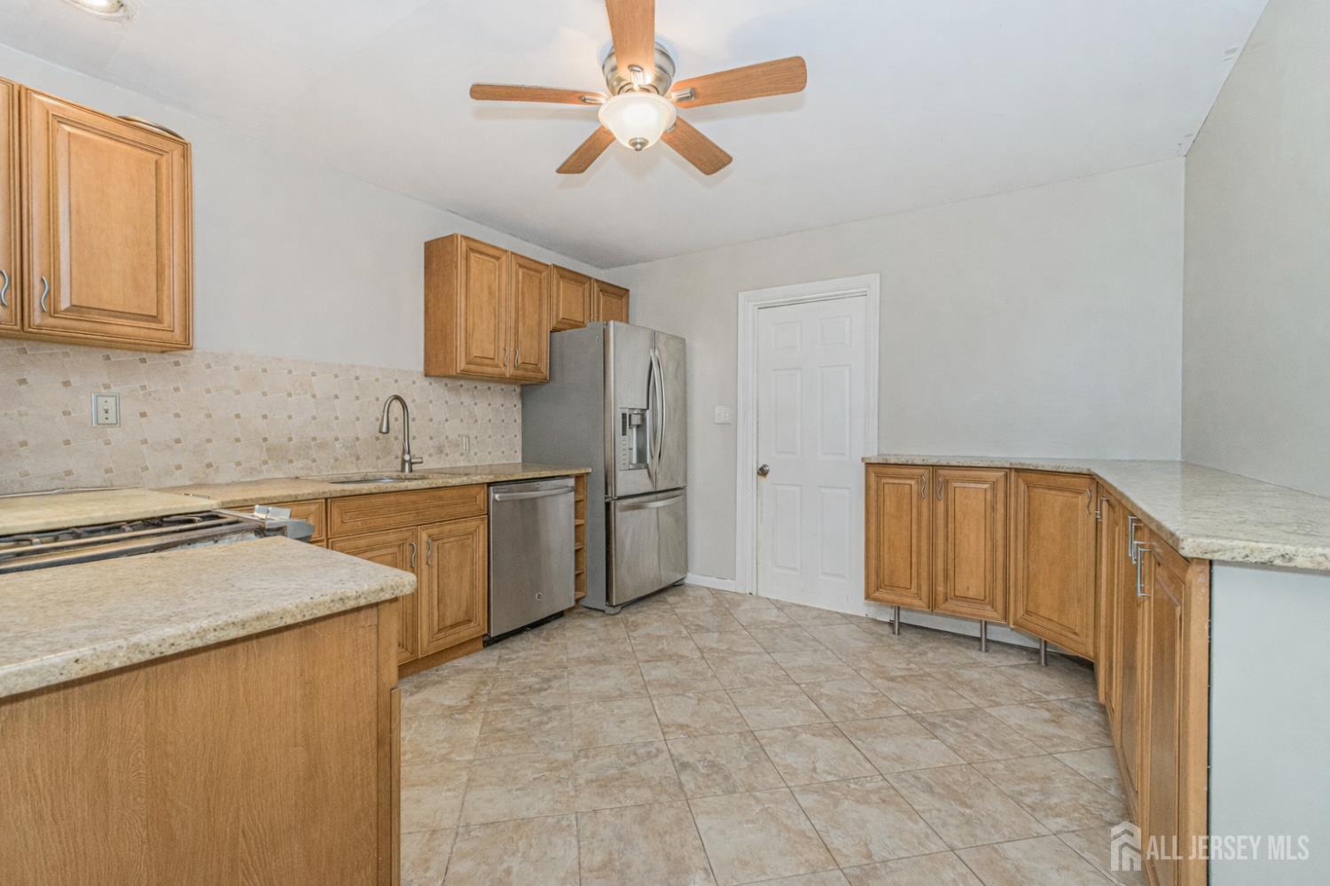 7 Walnut Lane Parlin, NJ 08859 - Photo 7 of 22 a kitchen with a sink a stove and cabinets