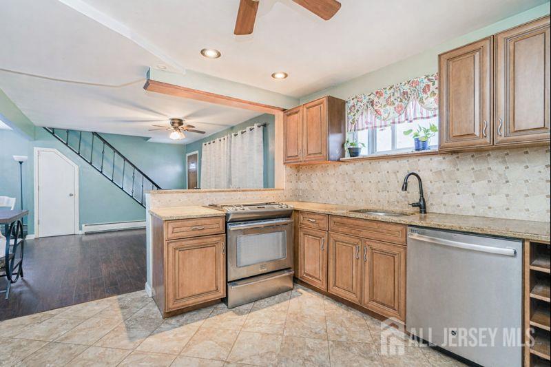 7 Walnut Lane Parlin, NJ 08859 - Photo 9 of 23 a kitchen with stainless steel appliances granite countertop a sink and cabinets