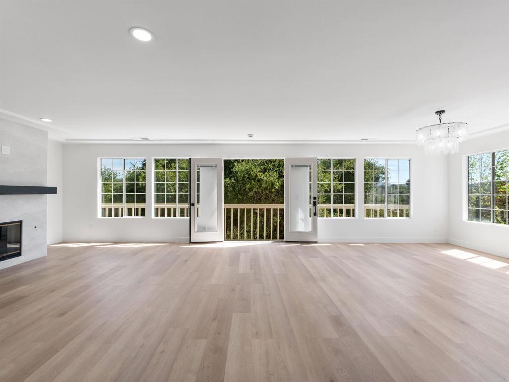 28148 Mountain Meadow Road Escondido, CA 92026 - Photo 11 of 51 a view of an empty room with wooden floor and a window