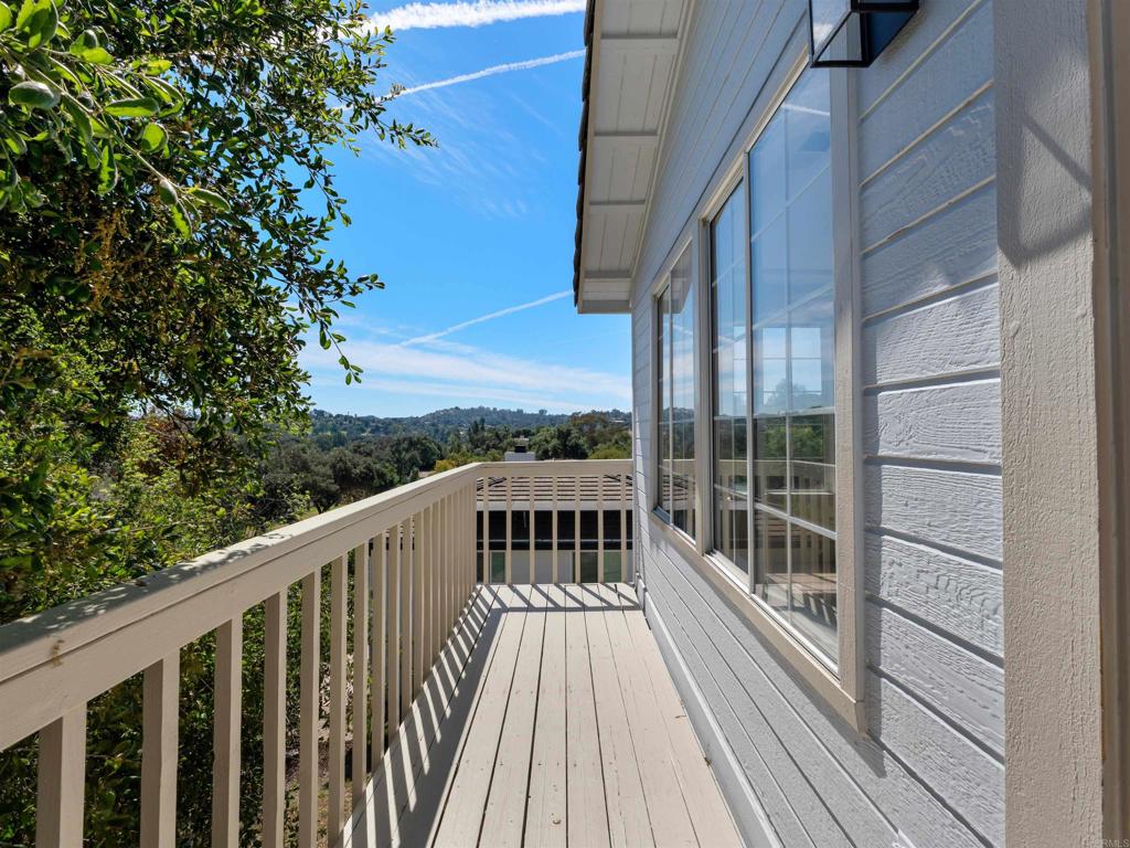 28148 Mountain Meadow Road Escondido, CA 92026 - Photo 12 of 51 a view of a balcony with wooden floor and fence