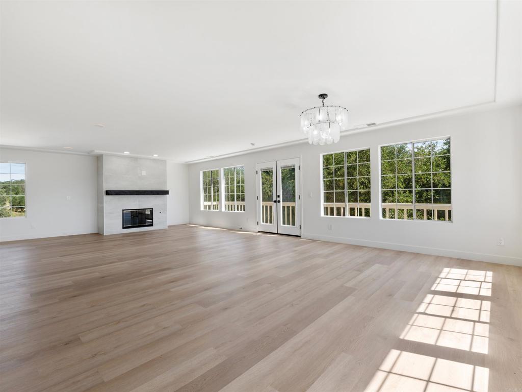 28148 Mountain Meadow Road Escondido, CA 92026 - Photo 13 of 51 a view of an empty room with wooden floor and a window