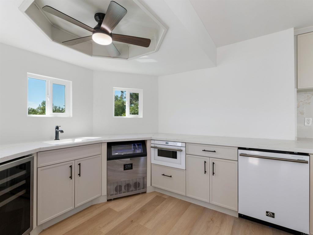 28148 Mountain Meadow Road Escondido, CA 92026 - Photo 18 of 51 a kitchen with white cabinets and appliances