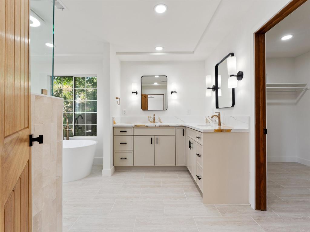 28148 Mountain Meadow Road Escondido, CA 92026 - Photo 26 of 51 a spacious bathroom with a double vanity sink a mirror a window and a shower