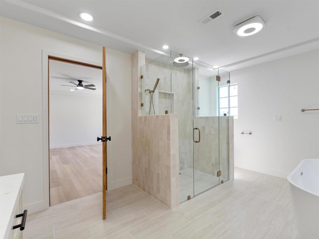 28148 Mountain Meadow Road Escondido, CA 92026 - Photo 27 of 51 a bathroom with a shower and a glass door