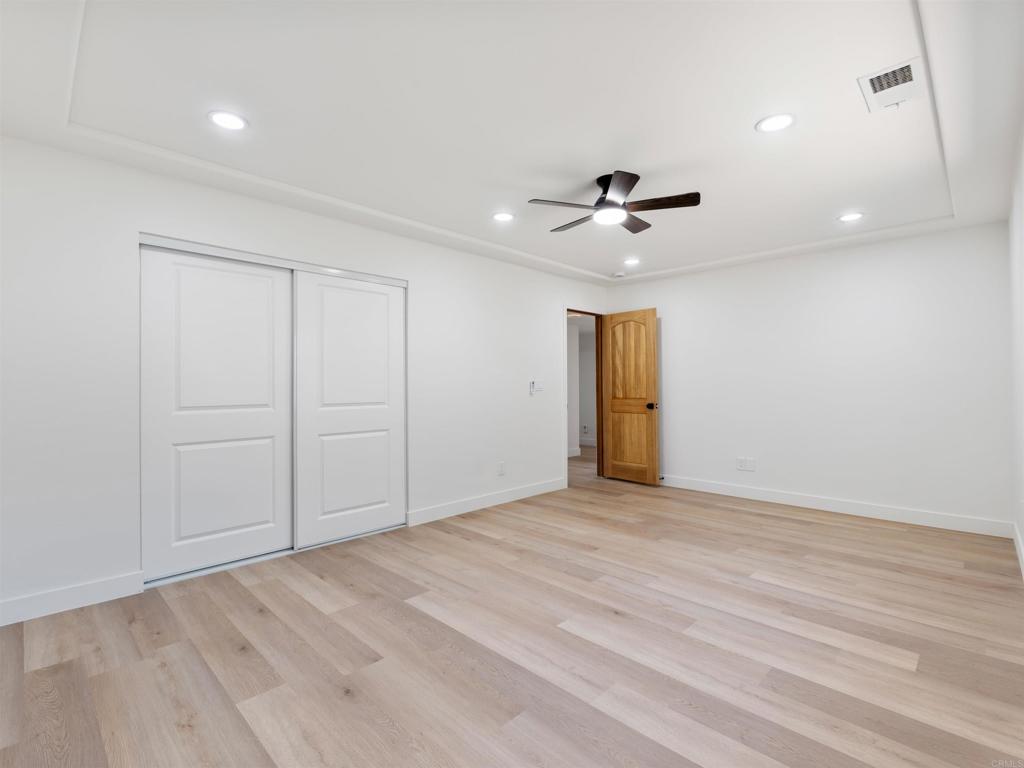 28148 Mountain Meadow Road Escondido, CA 92026 - Photo 31 of 51 wooden floor in an empty room with a ceiling fan