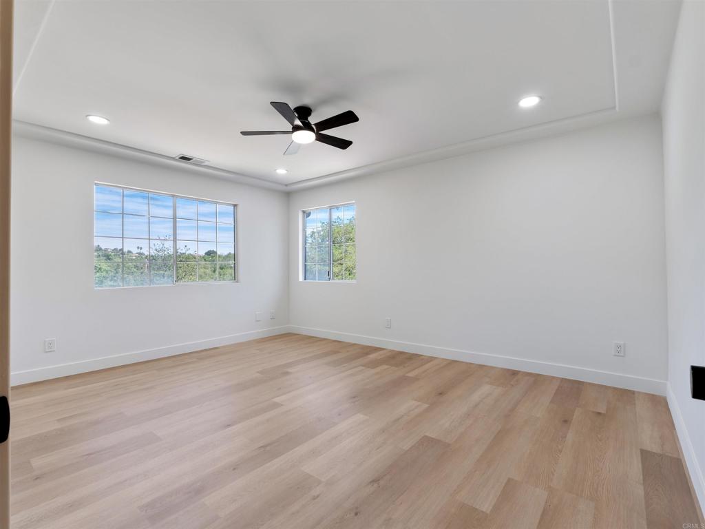 28148 Mountain Meadow Road Escondido, CA 92026 - Photo 32 of 51 an empty room with wooden floor fan and windows