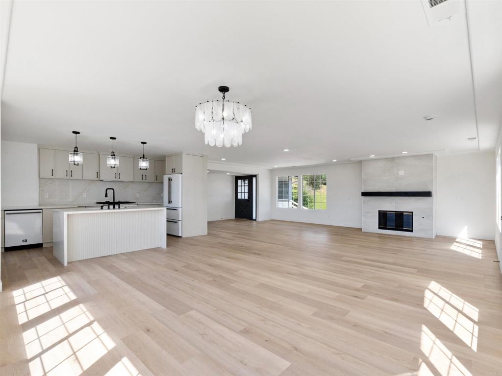 28148 Mountain Meadow Road Escondido, CA 92026 - Photo 6 of 51 a view of a kitchen with a sink and a fireplace