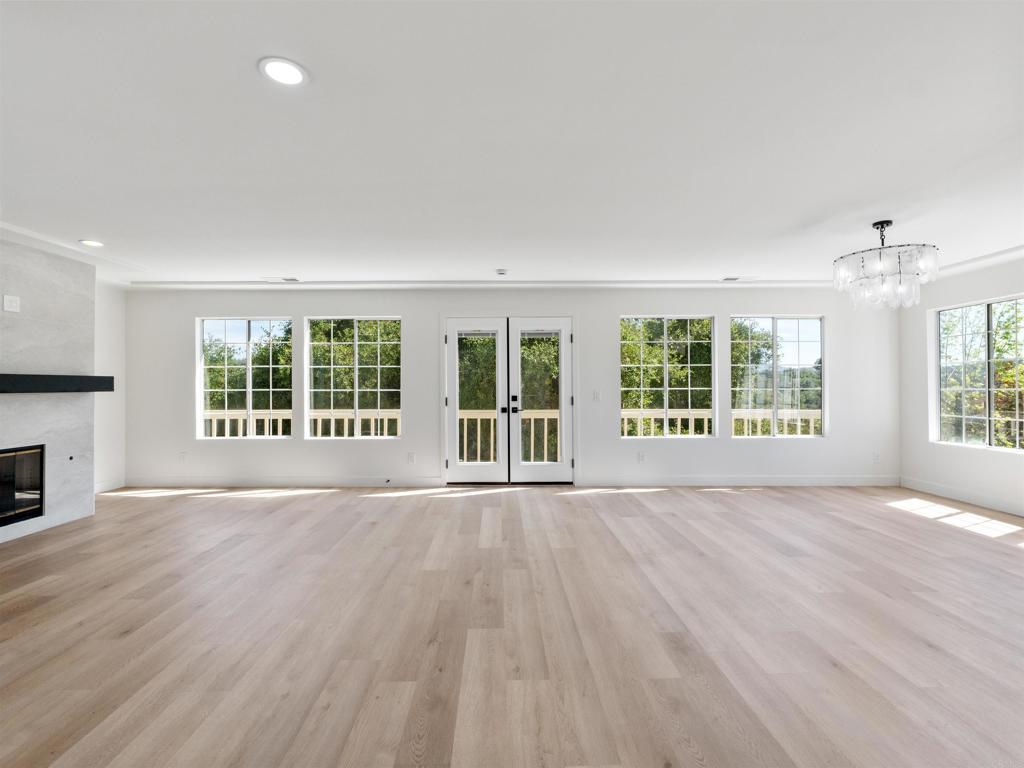28148 Mountain Meadow Road Escondido, CA 92026 - Photo 9 of 51 a view of an empty room with wooden floor and a window