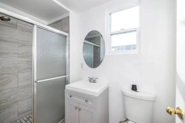a bathroom with a toilet sink and mirror