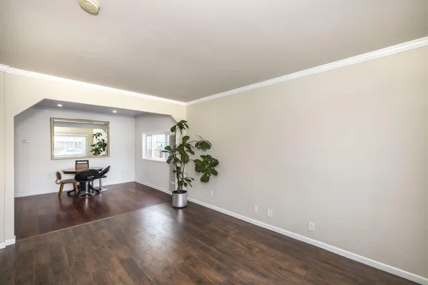 a view of an empty room and wooden floor