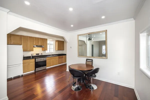 a large kitchen with a table and chairs in it