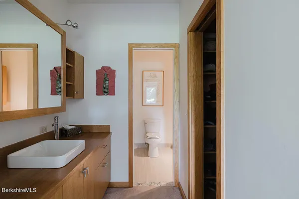 a en suite bathroom with a granite countertop sink and a mirror