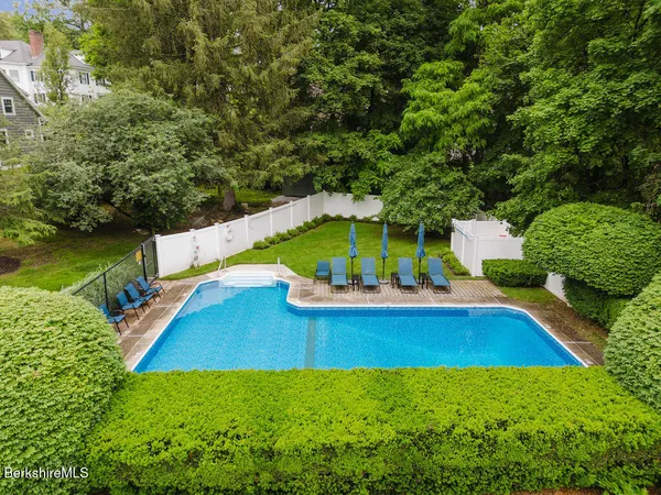 swimming pool with outdoor seating and yard