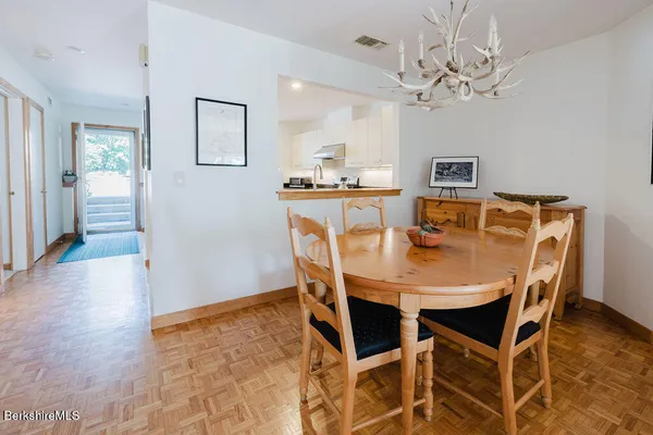 a view of a dining room with furniture and wooden floor