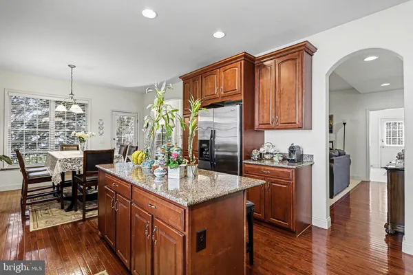 a kitchen with sink refrigerator and cabinets