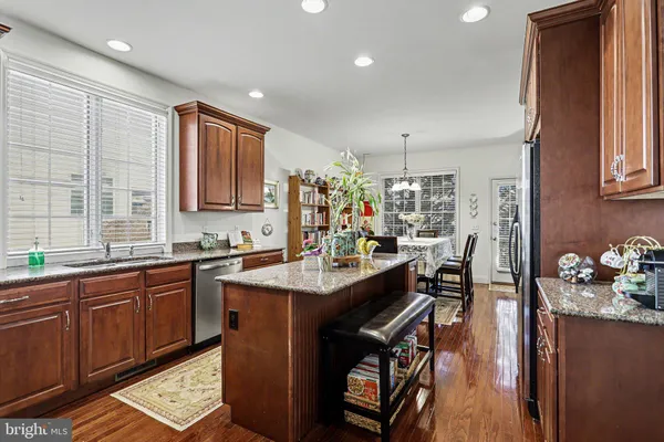 a kitchen with sink cabinets and wooden floor
