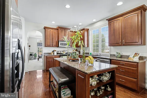 a kitchen with a refrigerator sink and cabinets