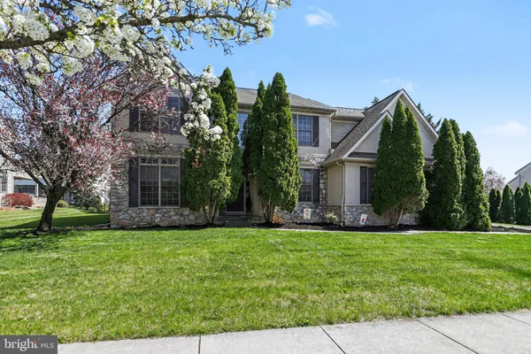 a front view of house with yard and green space
