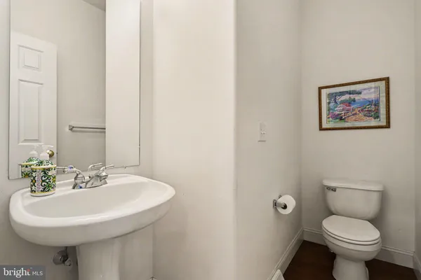 a bathroom with a sink toilet and a mirror
