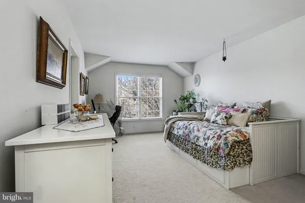 a bedroom with a bed and a table