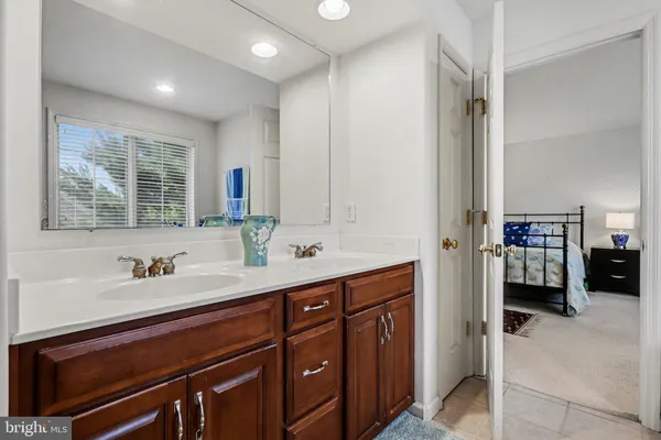 a en suite bathroom with a sink double vanity and a mirror
