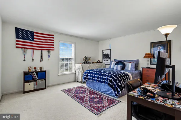 a bedroom with furniture and a window