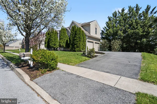 a front view of a house with a yard and a garage