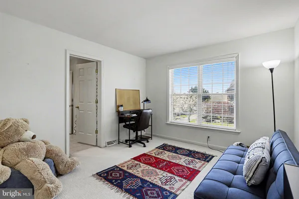 a living room with furniture a rug and a window