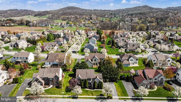 an aerial view of residential houses with outdoor space and river