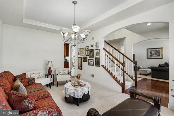 a living room with furniture chandelier and a chandelier