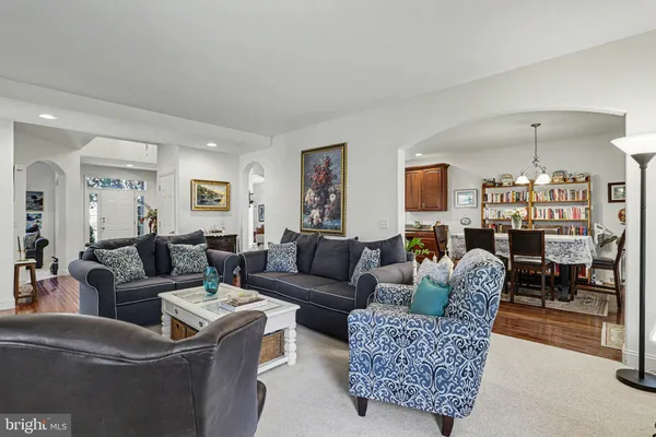 a living room with furniture and a chandelier