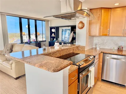 a living room with furniture and large windows