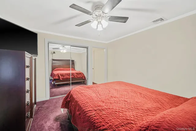 a bedroom with a bed and a closet