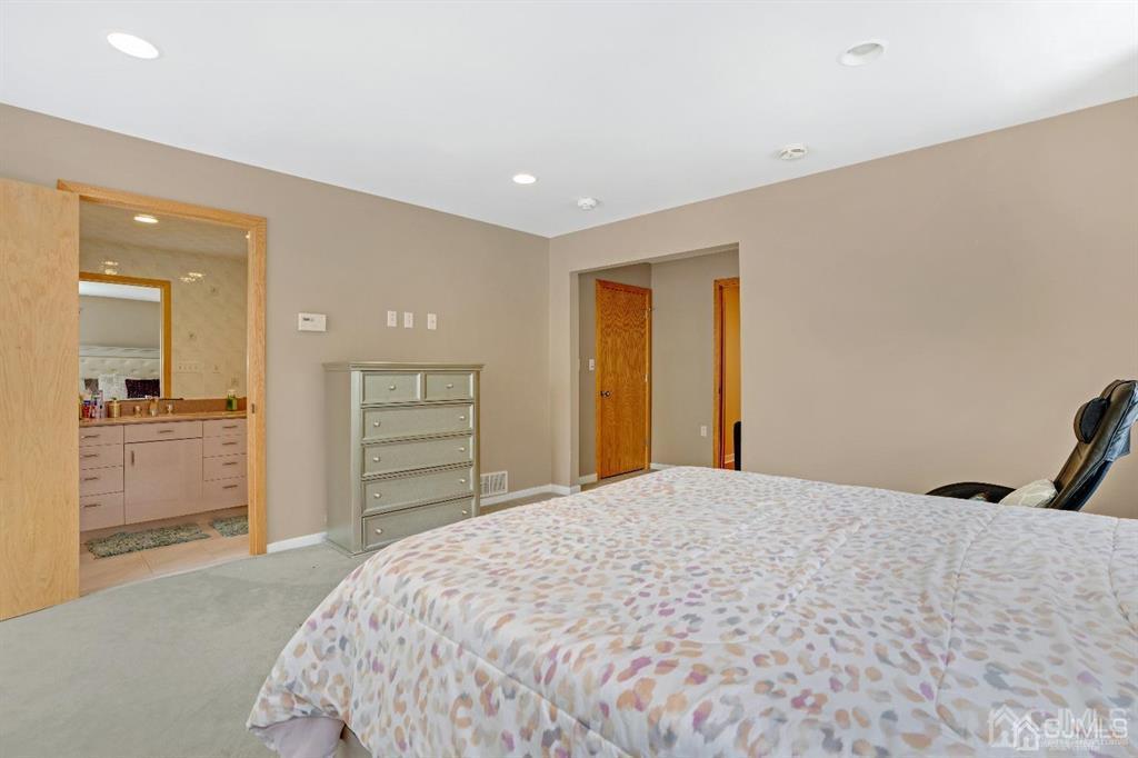 3 Clive Hills Road Edison, NJ 08820 - Photo 20 of 39 a bedroom with a bed and a mirror