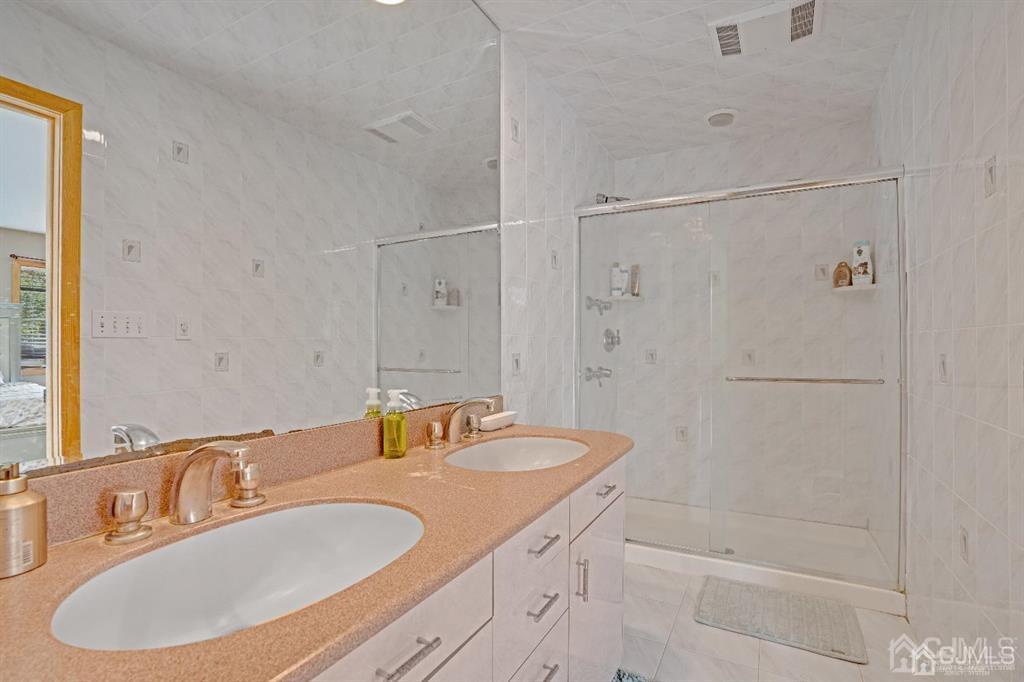 3 Clive Hills Road Edison, NJ 08820 - Photo 21 of 39 a bathroom with a sink and a mirror