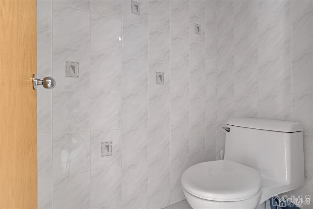 3 Clive Hills Road Edison, NJ 08820 - Photo 22 of 39 a white toilet sitting next to a white wall