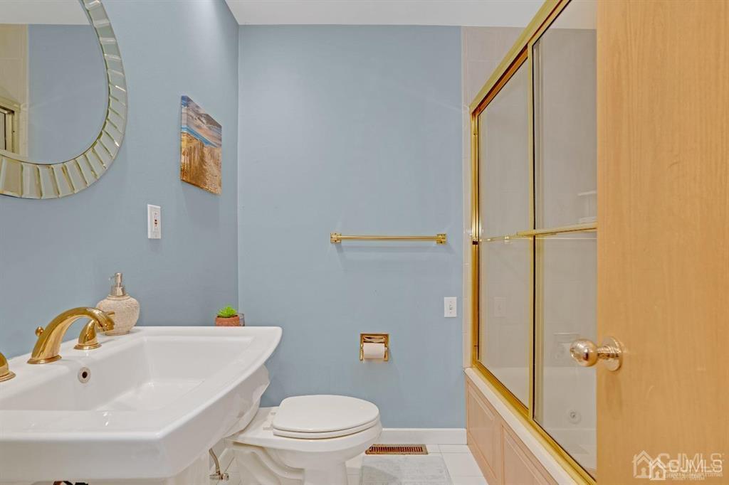 3 Clive Hills Road Edison, NJ 08820 - Photo 25 of 39 a bathroom with a sink mirror vanity and toilet