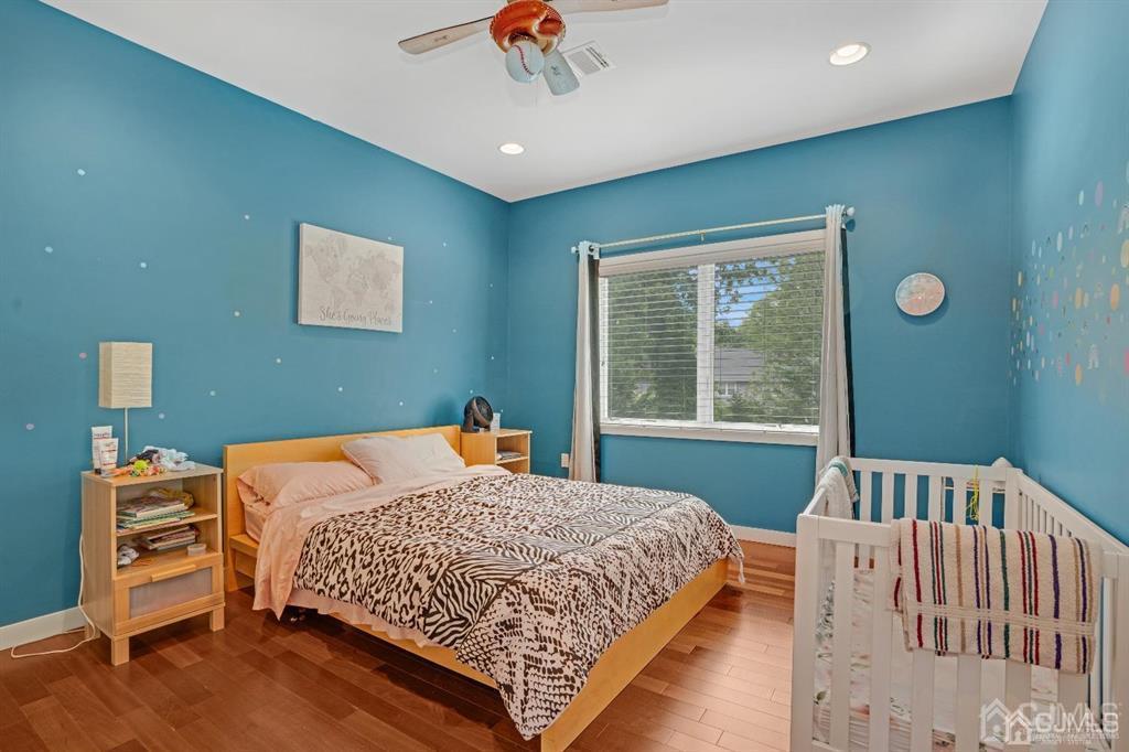 3 Clive Hills Road Edison, NJ 08820 - Photo 33 of 39 a bed sitting in a bedroom next to a window