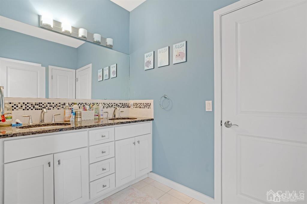 3 Clive Hills Road Edison, NJ 08820 - Photo 37 of 39 a bathroom with a sink and a mirror