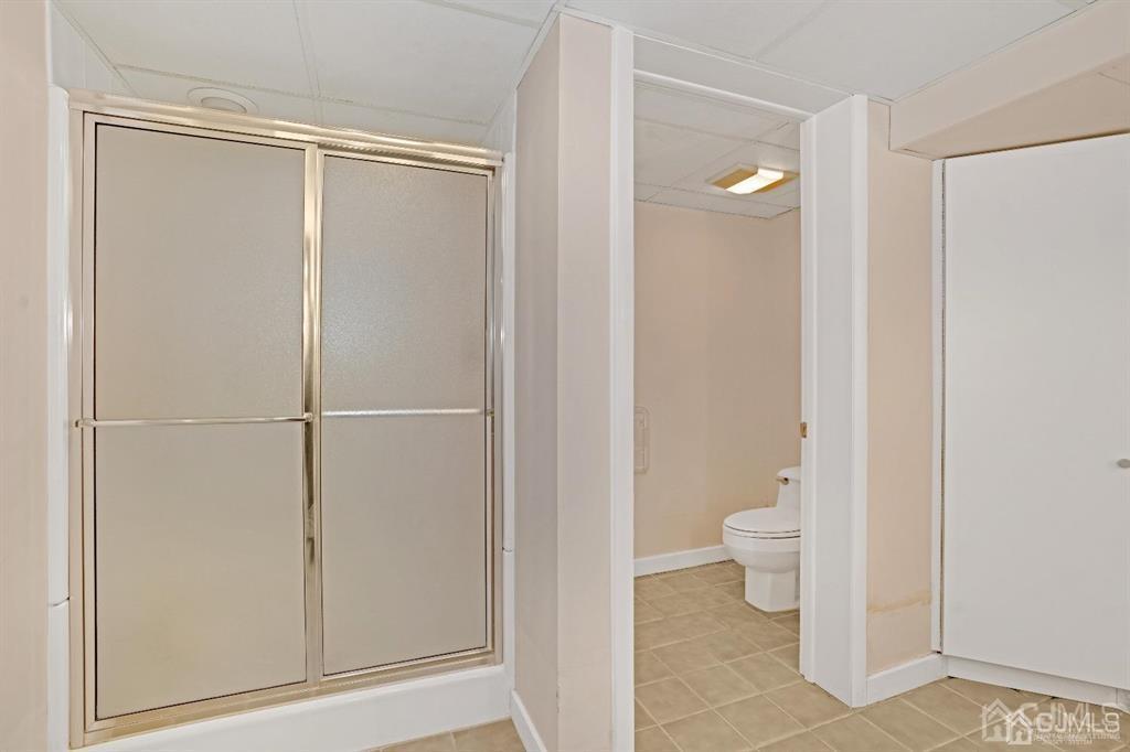 3 Clive Hills Road Edison, NJ 08820 - Photo 39 of 39 a bathroom with a granite countertop toilet and a shower