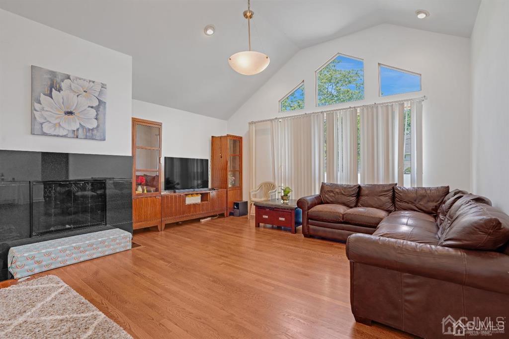 3 Clive Hills Road Edison, NJ 08820 - Photo 6 of 39 a living room with furniture and a flat screen tv